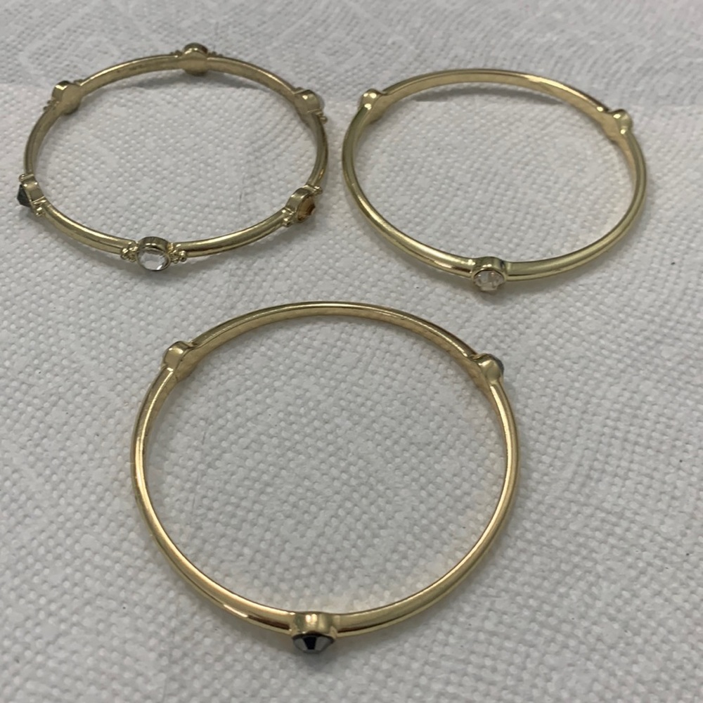 Bangles gold‎ tone bracelets with some stones.